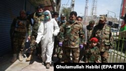 Afghan National Army personnel spray disinfectant during a lockdown in Jalalabad on April 9.