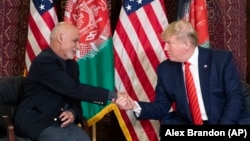U.S. President Donald Trump meets with Afghan President Ashraf Ghani during a surprise visit to the country, at Bagram Air Field, in November 2019. Trump is pushing to withdraw more troops before the November vote in order to meet a campaign pledge.