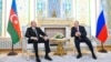 An image shows Russian President Vladimir Putin (right) meeting with Azerbaijani President Ilham Aliyev (left) on the sidelines of a summit in the Tajik capital, Dushanbe, on October 9.