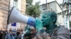 UKRAINE - Head of the non-governmental Anti-Corruption Action Centre Vitaliy Shabunin, who was splashed with brilliant green substance, uses a loud-speaker during a rally in front of the Specialized Anti-Corruption Prosecutor's Office in Kiev, Ukraine Jul