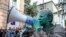 UKRAINE - Head of the non-governmental Anti-Corruption Action Centre Vitaliy Shabunin, who was splashed with brilliant green substance, uses a loud-speaker during a rally in front of the Specialized Anti-Corruption Prosecutor's Office in Kiev, Ukraine Jul