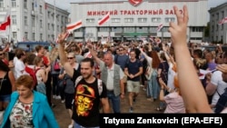 Workers leave the Minsk Wheeled Tractor Plant as opposition activists protest in Minsk on August 18.