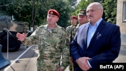 Belarusian President Alyaksandr Lukashenka (right) made the announcement while talking with Interior Ministry officers on July 28.