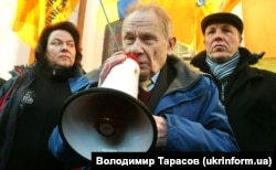 Юрий Шухевич (с мегафоном) и народный депутат Андрей Парубий (справа) во время акции протеста против отмены решения о присвоении Роману Шухевичу звания Герой Украины у здания Высшего административного суда Украины. Киев, 16 февраля 2011 года