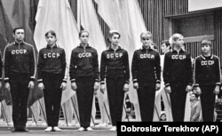 Coach Renald Knysh (left) poses with the Soviet women's gymnastics team in the Sports Palace in Minsk in 1977.