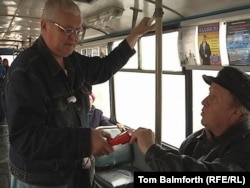 Aleksandr Zverkov (left) now works as a conductor on public transportation in Rybinsk.