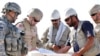 US and Afghan engineers review blueprints for an Afghan Army garrison in September 2008.