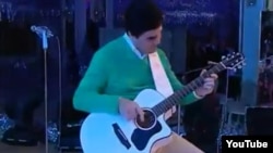 Гурбангулы Бердымухаммедов играет на гитаре.