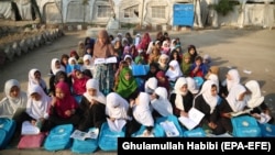 Afghan children attend an open-air class due to the lack of school facilities in the Sarhood district of Nangarhar Province on February 25.