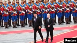 د روسیې ولسمشر ولادیمیر پوتین په منګولیا کې تر رسېدو وروسته د نظامي رژې د کتنې پر مهال لیدل کېږي.