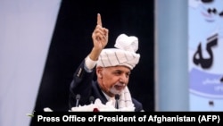 Afghan President Ashraf Ghani gestures as he speaks during the last day of the Loya Jirga or grand assembly in Kabul on August 9.