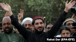 Leader of the Pashtun Tahafuz Movement (PTM) Manzoor Pastheen (C) waves to supporters during a demonstration in Lahore on April 22.