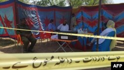 Pakistani officials wait to exhume the grave of Italian national of Pakistani origin Sana Cheema, who was allegedly killed by her family members, in Pakistan's Punjab Province on April 25.