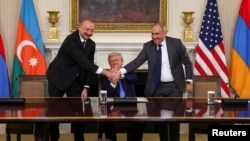 U.S. President Donald Trump holds the hands of Azerbaijan's President Ilham Aliyev and Armenia's Prime Minister Nikol Pashinian during a trilateral signing event at the White House, Washington, August 8, 2025.