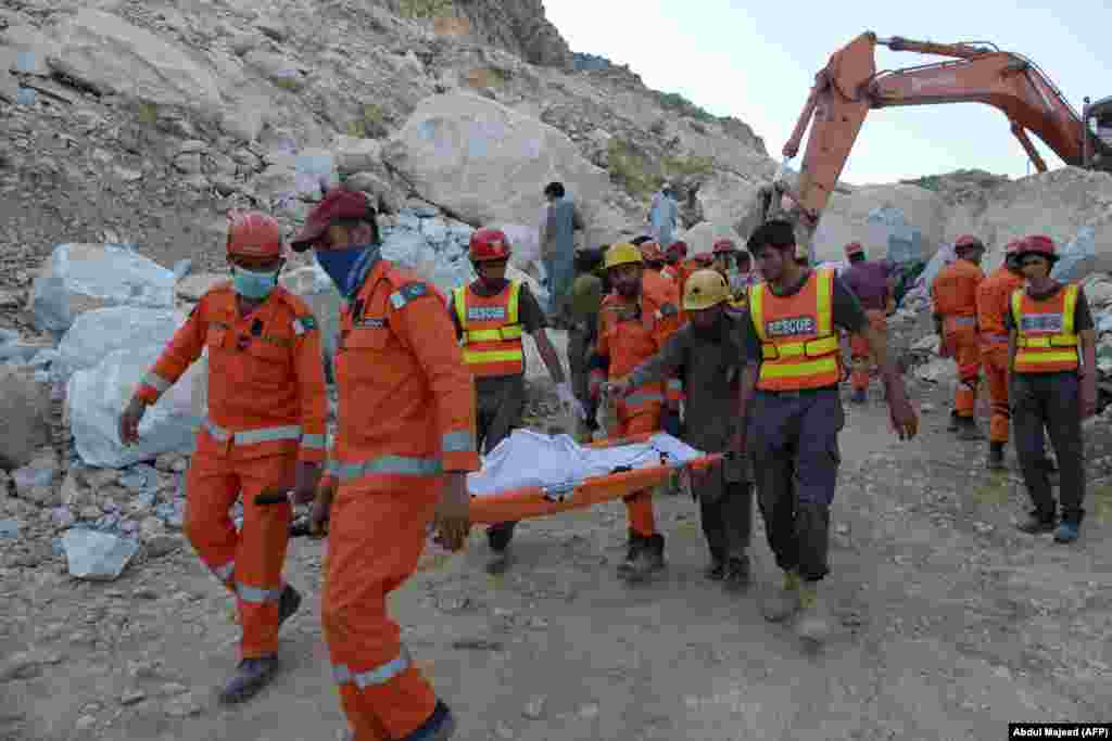 Army rescuers move the body of a miner from the site after a rockslide at a marble mine in the mountainous Mohmand district of Khyber Pakhtunkhwa Province.