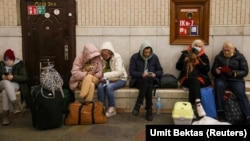 People gather at a subway station in Kyiv on February 24 as they seek shelter from expected Russian air strikes. 