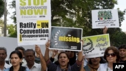 FILE: Pakistani human rights activists carry placards and banners during a protest to mark the International Day of the Victims of Enforced Disappearances in Karachi on August 30 2016.