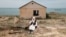 Cover for video - Woman in the village on the shores of the Caspian Sea. Photo by Ospan Ali  
