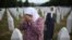 A woman mourns at the grave of her relative, a victim of the Srebrenica genocide, at the Memorial Center in Potocari, Bosnia, Friday, July 11, 2025.