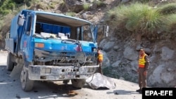 Pakistani rescue officials inspect the scene of a blast that targeted a bus carrying Chinese engineers to the site of the Dasu Dam in Upper Kohistan on July 14.