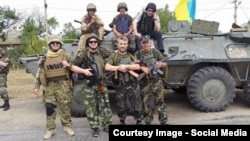 Isa Munaev (3rd from left) poses for a photo in Ukraine with members of his battalion.