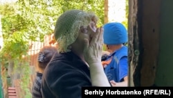 A woman bids farewell to her home in Ukraine's Kostyantynivka, Donetsk region, in late July.