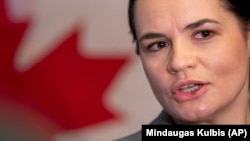 Belarusian opposition figure Svyatlana Tsikhanouskaya speaks to the members of press following a meeting with Canada's foreign minister in Vilnius on October 16.