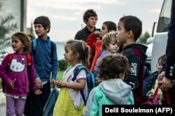 Russian children from the Al-Hawl camp are handed over to a delegation from their country in the northeastern Syrian city of Qamishli last month.