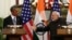 Indian Prime Minister Narendra Modi (R) reaches out to shake hands with U.S. President Barack Obama on January 25.