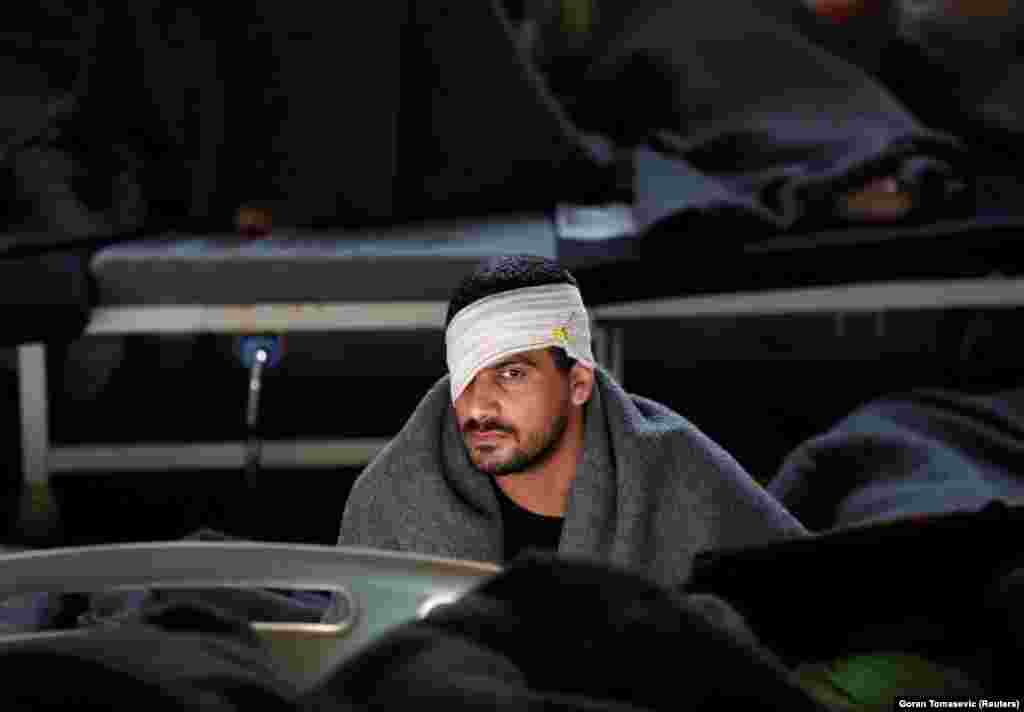 A man suspected of being part of the Islamic State militant group, sits inside a prison hospital in Hasaka, Syria.