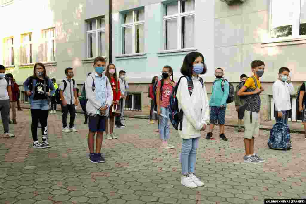 Elementary-school students wearing face masks keep their distance on the first day of school in Pristina, Kosovo.
