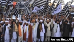 Supporters of pro-Taliban Pakistani religious Jamiat Ulema-e Islam Nazryate party rally to celebrate the signing agreement between United States and Taliban in Quetta Balochistan in March 2020. 
