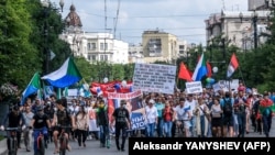 People carry a banner reading "Return Furgal to us" during a rally in support of Sergei Furgal in Khabarovsk on August 8.
