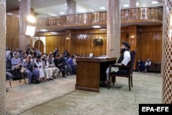 Taliban spokesman Zabihullah Mujahid talks with journalists during a press conference in Kabul on September 6.